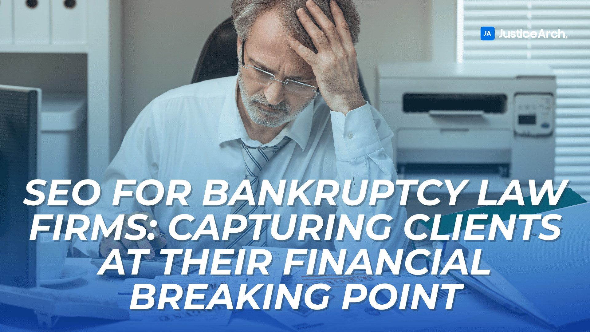Stressed middle-aged man in business attire holding his head at a desk, symbolizing financial strain, with text introducing SEO strategies for bankruptcy law firms.